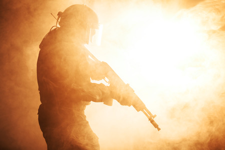 Russian special forces operator in bulletproof helmet in the smoke and fireの写真素材