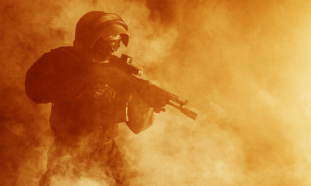 Russian special forces operator in bulletproof helmet in the smoke and fireの写真素材
