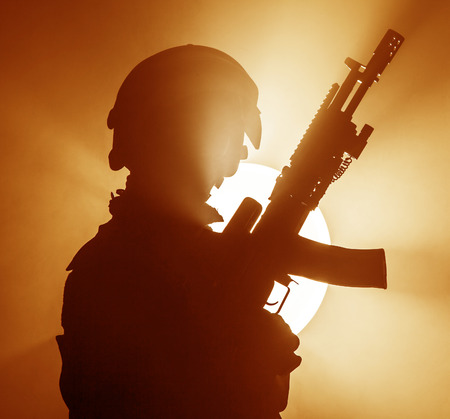 Russian special forces operator in bulletproof helmet in the smoke and fire