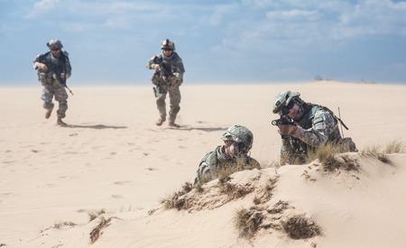 United States paratroopers airborne infantrymen in action in the desertの写真素材