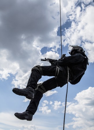 Special forces operator during assault rappeling with weaponsの写真素材