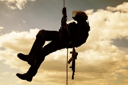 Special forces operator during assault rappeling with weaponsの写真素材