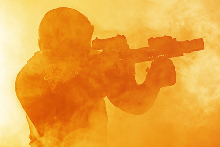 Police officer SWAT in black uniform in the smoke studio shotの写真素材