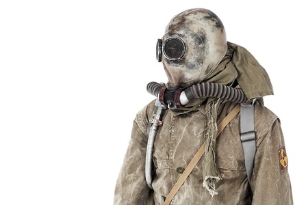 Nuclear post apocalypse. Studio shot of survivor in tatters and gas maskの写真素材