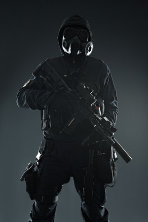 Nuclear post apocalypse. Studio shot of survivor with weapons and gas maskの写真素材