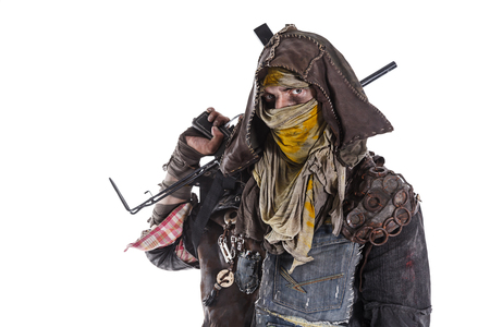 Nuclear post apocalypse life after doomsday concept. Grimy survivor with homemade weapons. Studio closeup portrait on white backgroundの写真素材