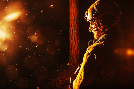 Image of soldier in the forest. Back light, cropped, toned and colorizedの写真素材