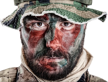 Special forces United States in Camouflage Uniforms studio shot. Wearing jungle hat, Shemagh scarf, painted with red and green face. Studio shot isolatedの写真素材