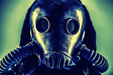 Close up portrait of nuclear post-apocalypse survivor, living underground mutant or creature, skilled stalker wearing rags and armored full-face gas mask or air breathing apparatus, toned shootの写真素材