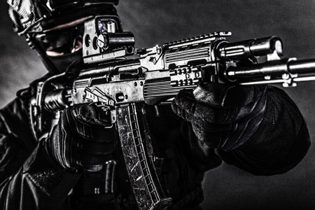 Modern assault rifle in hands of commando fighter
