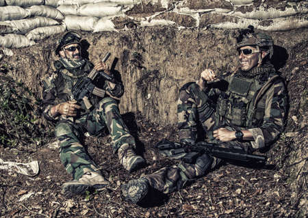 Navy SEALs soldiers, special operations forces fighters in camouflage uniform, body armor and...