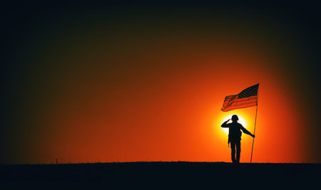 Silhouette of USA armed forces soldier, army infantryman or Marine Corps fighter saluting while standing with waving national flag on sunset background. Military victory and glory, fallen remembranceの写真素材