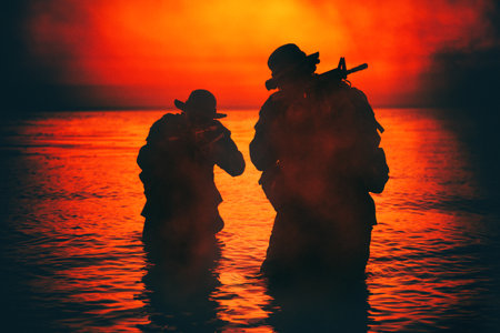 Commando soldiers walking in water, army special operations forces fighters sneaking in darkness, aiming assault rifles and observing shore during amphibious operation on coast at night or dawnの写真素材