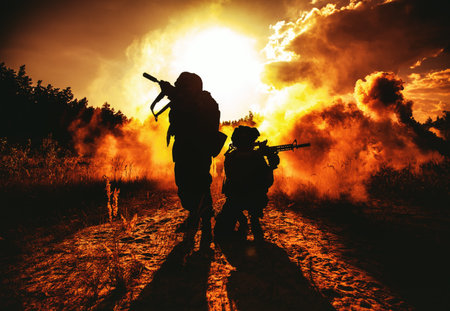 United States Marines in action. Military action, desert battlefield, smoke grenades., fire and explosions. Sun setting, dark silhouettes in the desertの写真素材