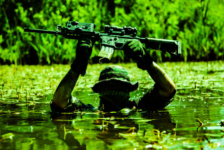 A soldier moves in the heart of a marsh, submerged in swampy waters with only arms and rifle...