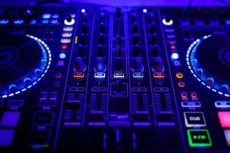 closeup view of a DJs mixing desk