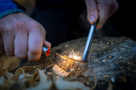 Outdoors makeing fire by flint. Closeup view.の写真素材