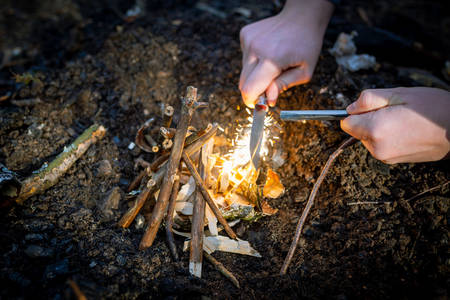 Outdoors makeing fire by flint. Closeup view.の写真素材