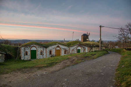 Tiny old stone wine cellars in Vrbice, South Moravia in the Czech Republic at sunset