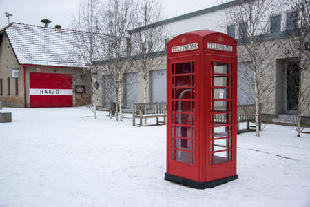 A red London telephone box stands in the snow in the village of Bedrichovice in the Czech Republicのeditorial素材