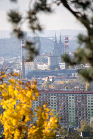 View of the city of Brno (Czech Republic) through the trees near the autumn forest.の写真素材