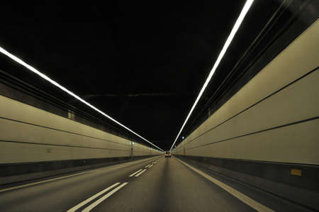Oresund tunnel connecting Denmark and Sweden underwater under sea level. Highway driving fast through a dark tunnel.のeditorial素材