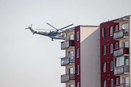 Brno, Czech Republic: Two combat helicopters fly low over houses right in the city.