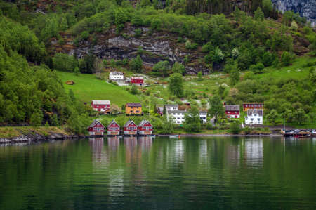 A small village with colorful wooden houses on the shores of a fjord in Norway.の写真素材