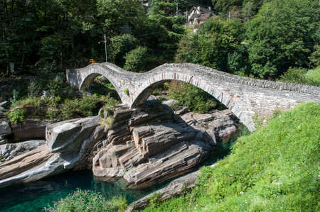 Old stone bridge over the river in the Verzasca valley in Switzerland. The bridge for hikers is an important monument.の写真素材
