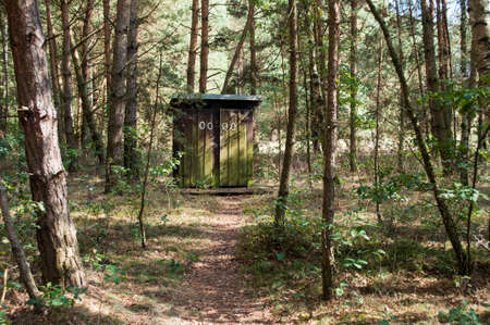Old wooden toilets stand in the middle of the forest.の写真素材