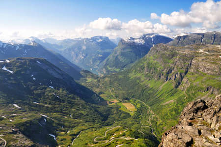 Panorama of high mountains with a deep valley in the north of Europe in Norway in the town of Geiranger.の写真素材