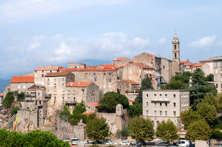 Old buildings of the town of Sartene on the island of Corsica in France. Town with houses and church tower in the mountains.の写真素材