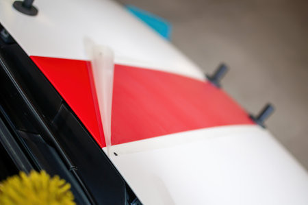 Installation of red foil stripes as a car sticker. Fast stripe decals on car.の写真素材