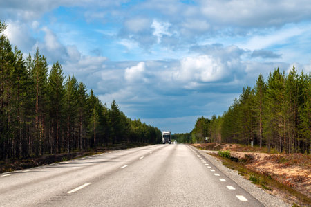 Empty wide road in the forest in the north of Europe in Sweden.の写真素材