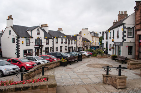 Melrose, Scotland - July 15, 2012: Main square in Melrose, UK with old white houses and flags as decoration.のeditorial素材