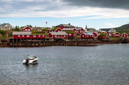 A small village with wooden red houses on the sea coast in Norway on the Lofoten Islands.