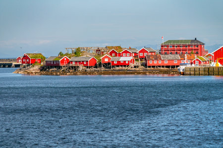 A small village with wooden red houses on the sea coast in Norway on the Lofoten Islands.