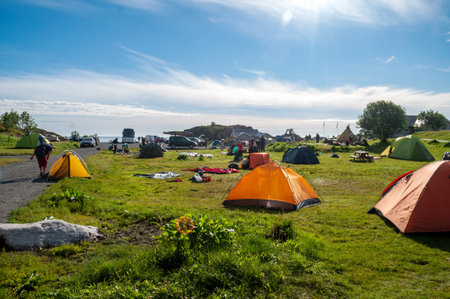 Moskenes, Norway - July 20, 2015: Colorful tents in the morning on a meadow in a campsite on the Lofoten Islands in northern Europe.のeditorial素材