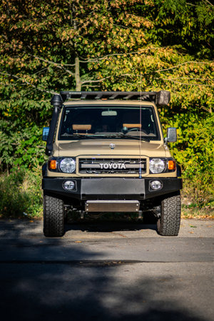 Brno, Czech Republic - October 4, 2023: Beige Toyota Land Cruiser SUV parked outside in the forest. Off-road travel car outside in the sunlit nature.のeditorial素材