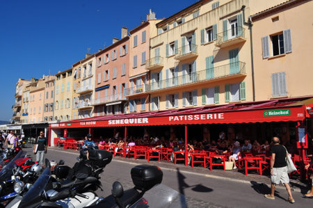 Saint Tropez, France - October 2, 2011: Main street with the legendary red bar on the waterfront by the port.のeditorial素材