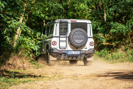Brno, Czech Republic - October 6, 2023: Ineos Grenadier all-terrain vehicle in the forest on a dirt road between the treesのeditorial素材