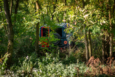 Brno, Czech Republic - October 6, 2023: Ineos Grenadier all-terrain vehicle in the forest on a dirt road between the treesのeditorial素材