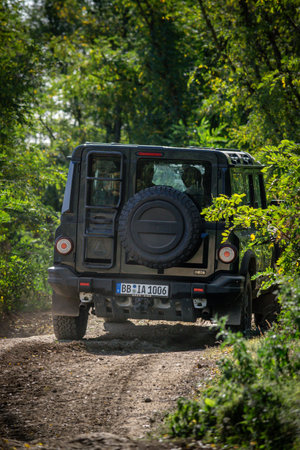 Brno, Czech Republic - October 6, 2023: Ineos Grenadier all-terrain vehicle in the forest on a dirt road between the treesのeditorial素材