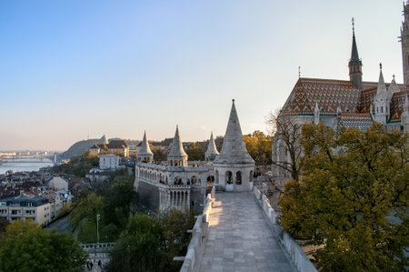 Old buildings with towers illuminated by the setting sun and stone pavement on the promenade of the Fisherman's Bastion in Budapest, Hungaryのeditorial素材