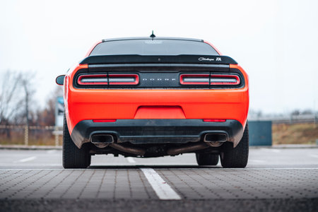 Brno, Czech Republic - December 31, 2023: A red Dodge Challenger is parked in the parking lot. Fast luxury sports car. American muscle car rear view and lights.のeditorial素材