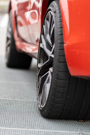 Brno, Czech Republic - November 25, 2023: Detail of the rear wheel of a red SUV with a black disc.
