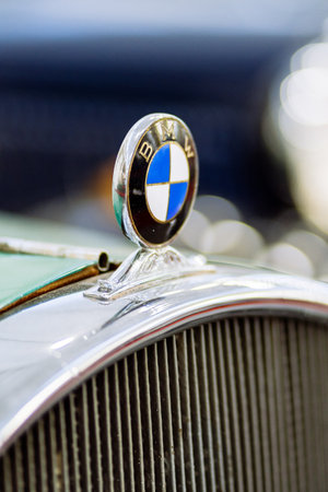 Brno, Czech Republic - November 25, 2023: Detail of the logo on the hood of an old historic car placed above the chrome grille. Round BMW logo on an old car.のeditorial素材