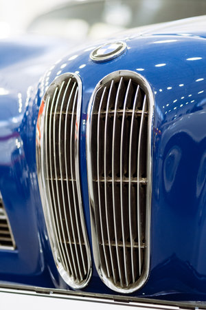 Brno, Czech Republic - November 25, 2023: Front detail of an old blue historic car with mask and chrome grille.のeditorial素材