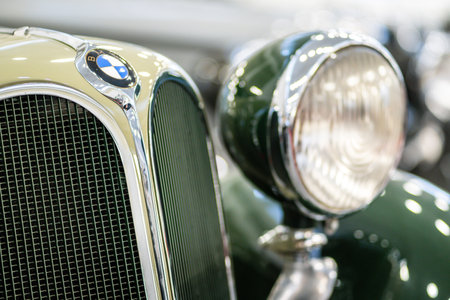 Brno, Czech Republic - November 25, 2023: Detail on the light of an old historic car with a front mask and a chrome grille.のeditorial素材