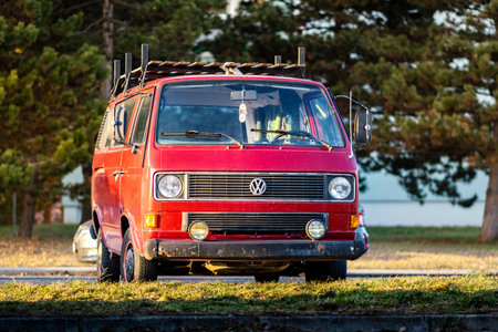 Brno, Czech Republic - February 5, 2024: Red old classic minivan Volkswagen Transporter T3 from the...